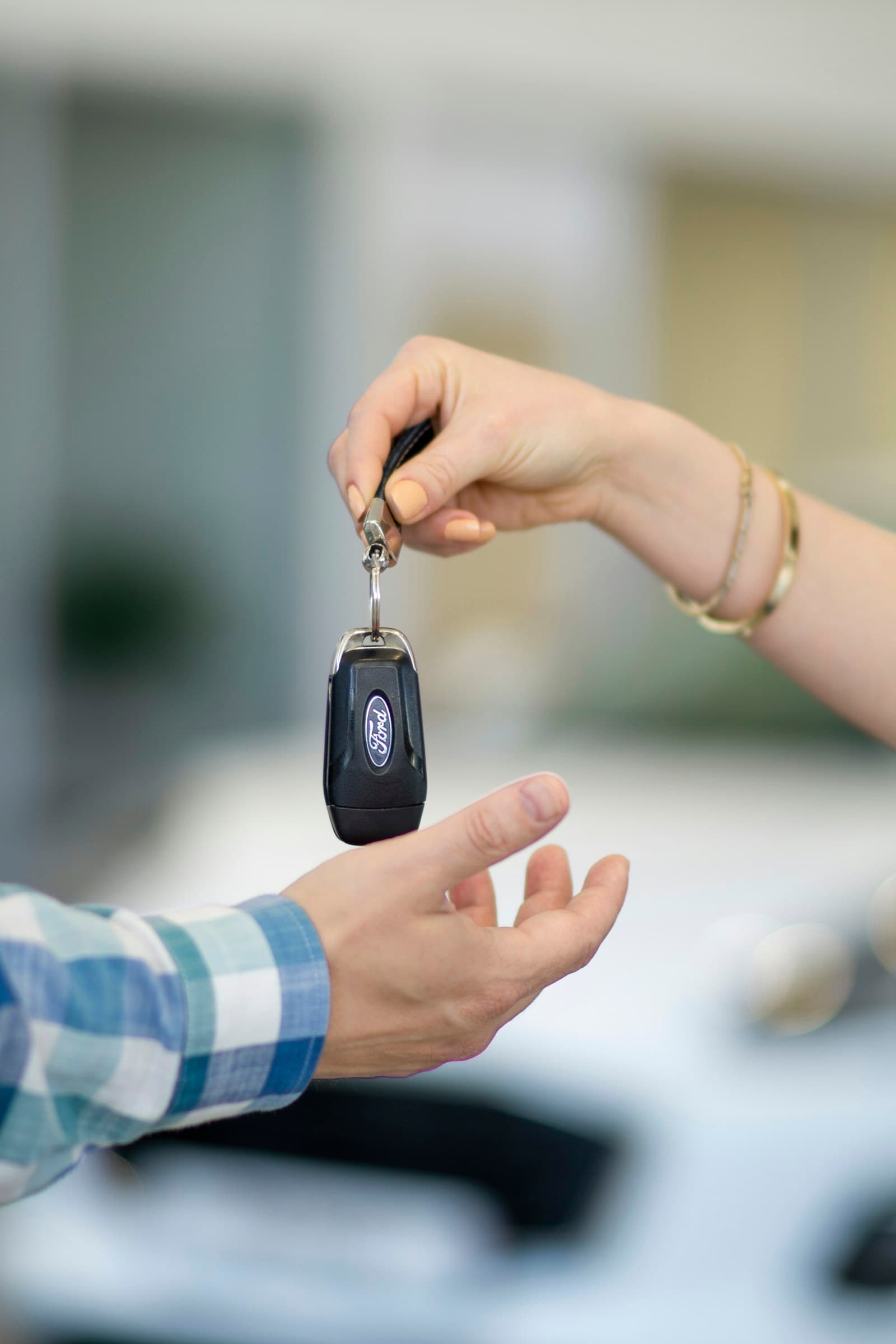 Salesperson handing over the keys at delivery